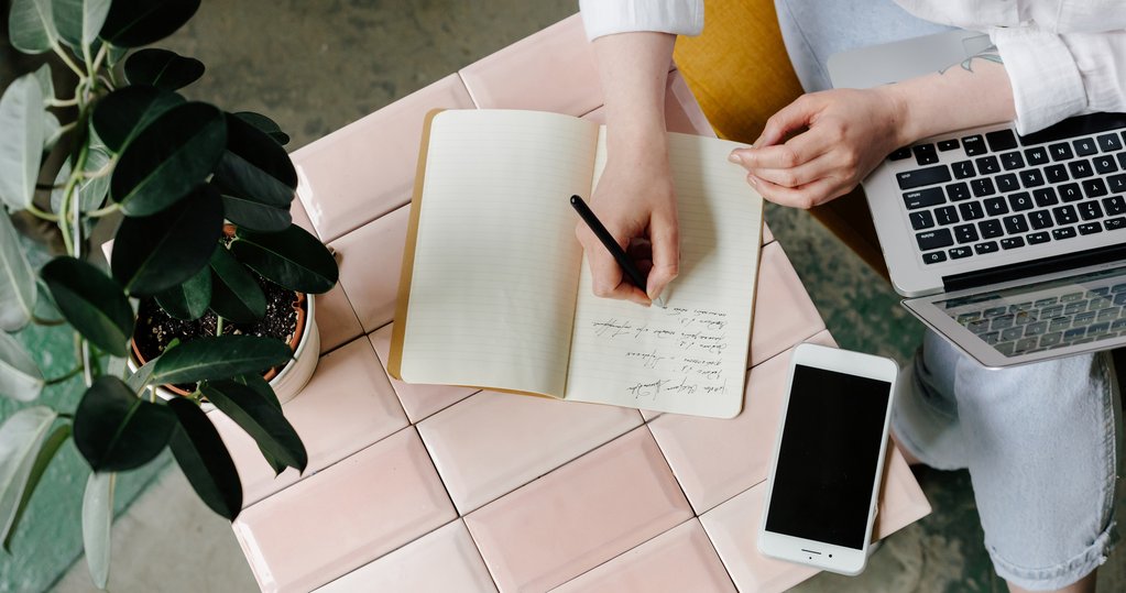 Woman writing in a notebook.