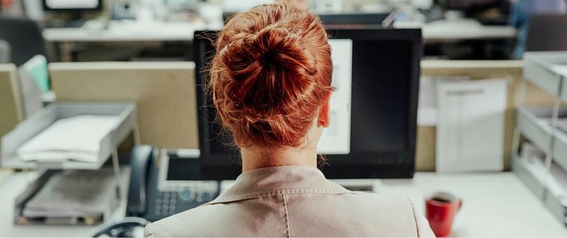 Woman sitting at her desk thinking about resigning